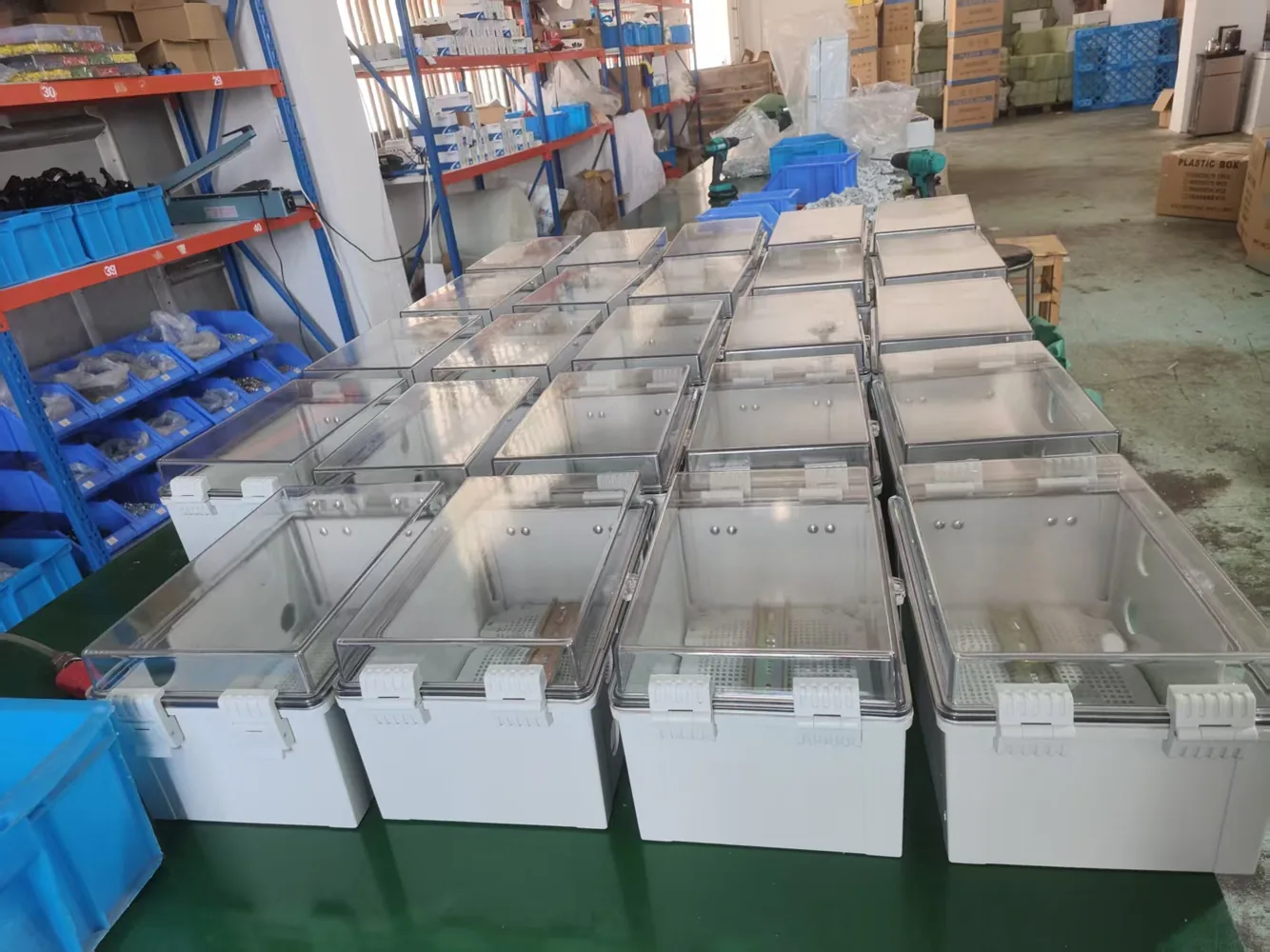 Waterproof electrical enclosures arranged on assembly table